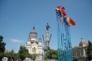 StatusFountainFlagsCathedral Romanian Flags with the fountain, statue, and cathedral in the background