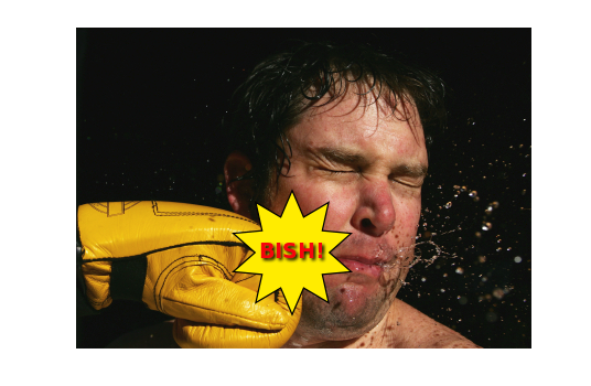 Kaboom! A man being punched by Batman